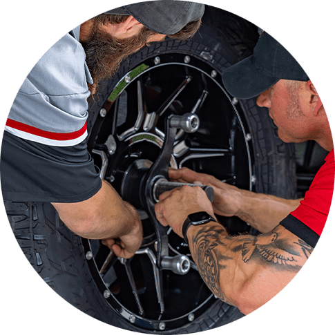 Employees at Pit Stop 171 in Longville Louisiana perform tire rotation