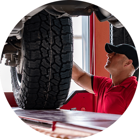 Employee at Pit Stop 171 in Longville Louisiana adds off road accessories to a lifted truck
