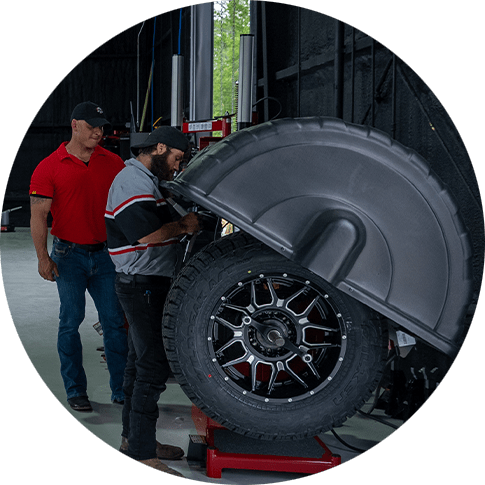 Employees at Pit Stop 171 in Longville Louisiana performs tire alignment